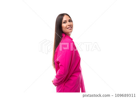 stylish caucasian woman with black straight hair is dressed in a crimson shirt on a white background 109689311