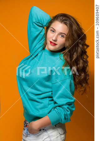 Portrait gloomy young brunette woman with wavy hair Portrait gloomy young brunette woman with wavy hair 109689407