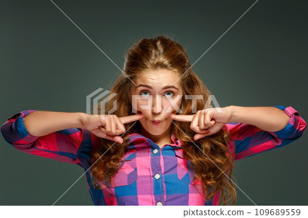 Portrait playful young brunette woman Portrait playful young brunette woman 109689559