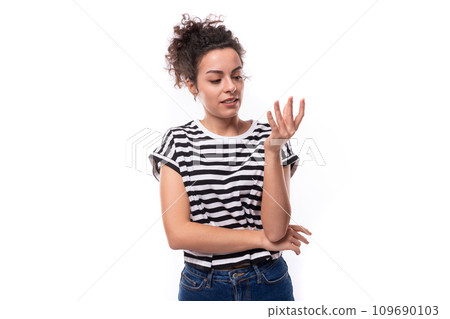 a young well-groomed curly woman with black hair in a summer T-shirt actively gesticulates 109690103