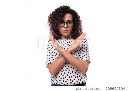 young confident leader woman with curly hairstyle dressed in summer blouse crossed her arms in front young confident leader woman with curly hairstyle dressed in summer blouse crossed her arms in front 109690104