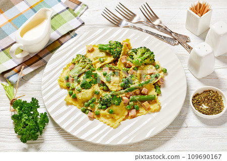 ravioli primavera with ham on a white plate 109690167
