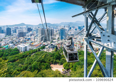 The cable car ride to N-Seoul Tower offers a stunning city view, making it a popular tourist spot in Seoul. 109690824