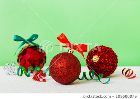 Christmas ball on colored background. decoration bauble with ribbon bow with copy space Christmas ball on colored background. decoration bauble with ribbon bow with copy space 109690879