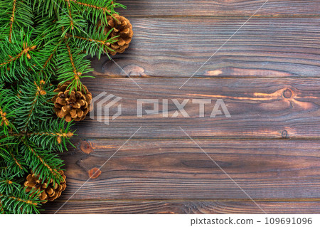 Christmas gray wooden background with fir tree frame and cones copy space. top view empty space for your design 109691096