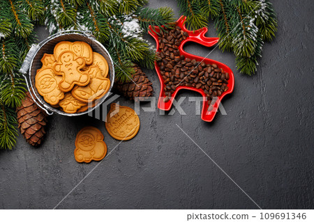 Christmas background with fir tree, gingerbread cookies, nuts, and copy space for greetings 109691346