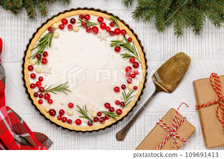 Christmas cake adorned with berries and rosemary 109691413