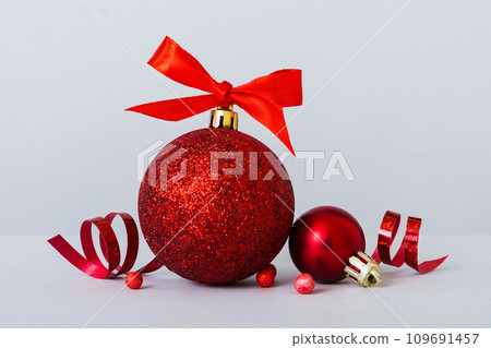 Christmas ball on colored background. decoration bauble with ribbon bow with copy space 109691457