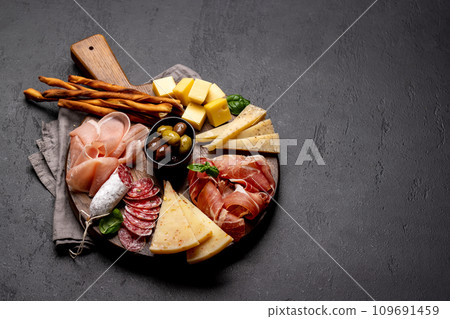 Antipasto board with various meat and cheese snacks 109691459