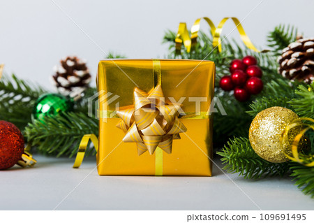 New Year Christmas mood, gift box, branches of a christmas tree, New Year decorations on a colored background 109691495