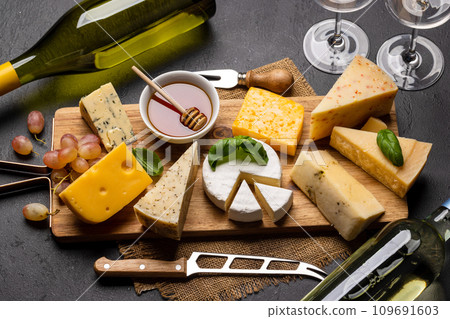 Various cheese on board and white wine Various cheese on board and white wine 109691603