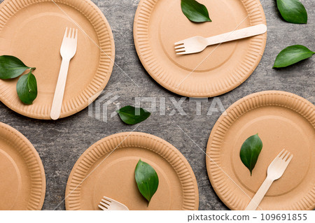 set of empty reusable disposable eco-friendly plates, cups, utensils on light white colored table background. top view. Biodegradable craft dishes. Recycling concept. Close-up set of empty reusable disposable eco-friendly plates, cups, utensils on light white colored table background. top view. Biodegradable craft dishes. Recycling concept. Close-up 109691855