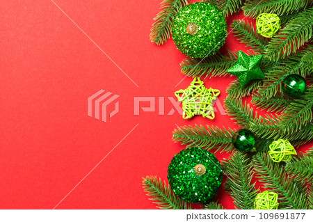 Set of festive balls, fir tree and Christmas decorations on colorful background. Top view of New Year ornament concept with copy space 109691877