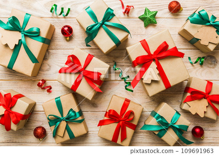 Colored craft gift boxes with colorful ribbons on colored background. Collection of Christmas present boxes Colored craft gift boxes with colorful ribbons on colored background. Collection of Christmas present boxes 109691963