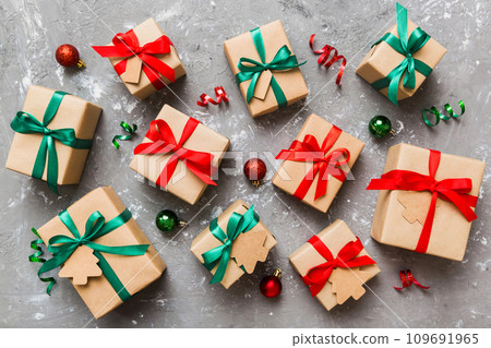 Colored craft gift boxes with colorful ribbons on colored background. Collection of Christmas present boxes Colored craft gift boxes with colorful ribbons on colored background. Collection of Christmas present boxes 109691965