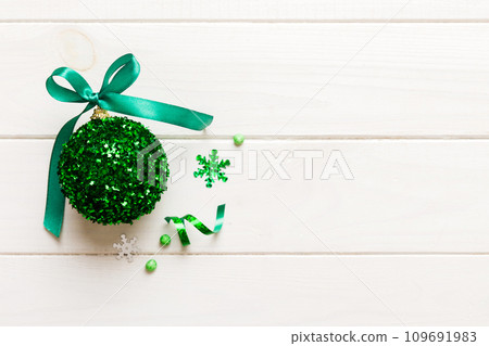 Christmas ball on colored background. decoration bauble with ribbon bow with copy space 109691983