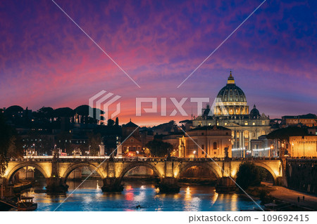 Rome, Italy. Papal Basilica Of St. Peter In The Vatican And Aelian Bridge In Evening Night Illuminations Rome, Italy. Papal Basilica Of St. Peter In The Vatican And Aelian Bridge In Evening Night Illuminations 109692415