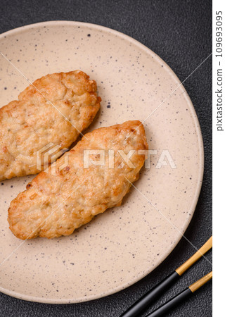 Delicious fresh fried minced fish or chicken cutlets with spices and herbs 109693095