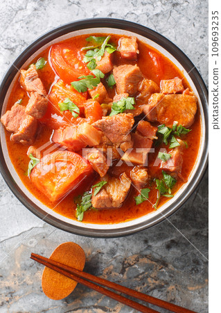 Chinese Indonesian Babi Tomat pork stewed tomato closeup in a bowl. Vertical top view 109693235