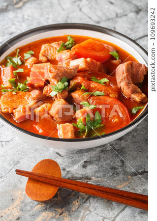 Chinese Indonesian Babi Tomat pork stewed tomato closeup in a bowl. Vertical 109693242