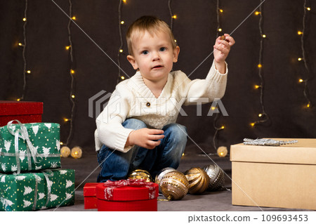 Portrait of happy little child playing with Christmas toys. Portrait of happy little child playing with Christmas toys. 109693453