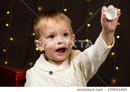 Portrait of happy little child playing with Christmas toys. 109693468