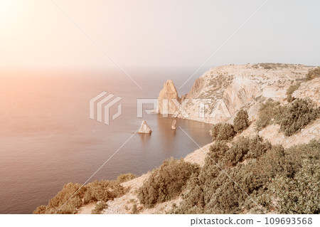 Aerial view from above on calm azure sea and volcanic rocky shores. Small waves on water surface in motion blur. Nature summer ocean sea beach background. Nobody. Holiday, vacation and travel concept 109693568