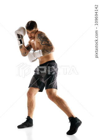 Full-length image of young muscular man, boxing athlete in motion, training isolated over white background Full-length image of young muscular man, boxing athlete in motion, training isolated over white background 109694142