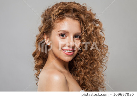 Cheerful young female model healthy woman with long wavy frizzy hairstyle  109697050