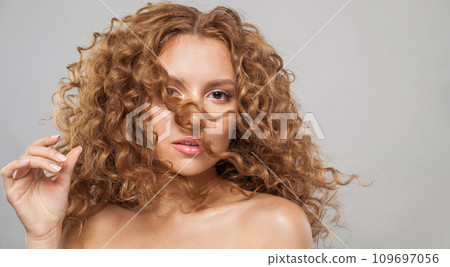 Attractive redhead woman fashion model with shiny curly brown hair and natural healthy fresh skin Attractive redhead woman fashion model with shiny curly brown hair and natural healthy fresh skin 109697056