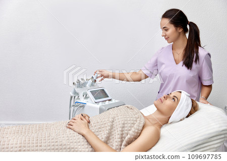 beautiful woman lying on bed during skincare procedure in beauty clinic. 109697785