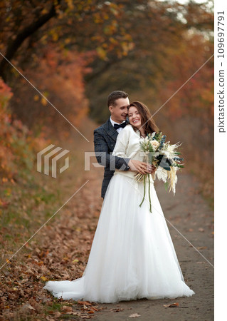 happy wedding couple standing outdoor on natural background 109697791