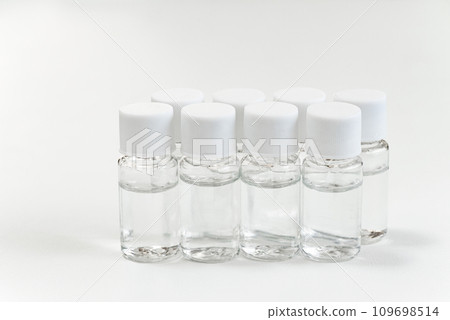Plastic sample mini bottle with liquid on white background 109698514