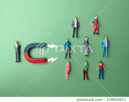 Top view miniature businessman attracts people using magnet. Business concept. 109698652