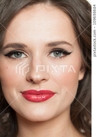 Female face closeup. Young glamorous fashionable brunette model woman with wavy hairstyle 109698684