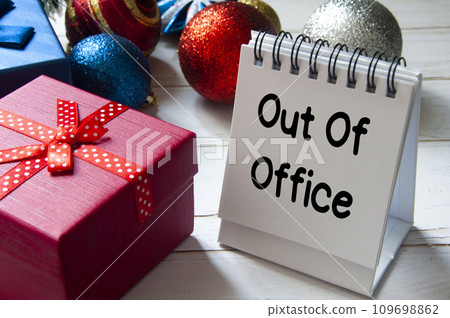 Out of office text on notepad with Christmas decoration. Holiday concept. 109698862