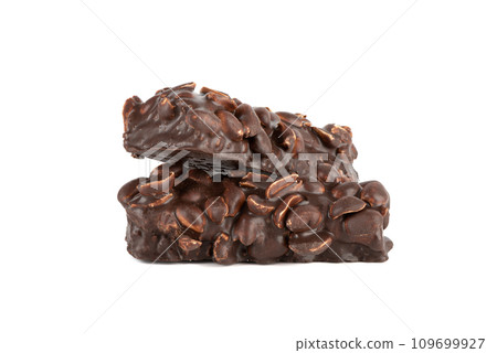 Two bars of sweet brownies with nuts and covered with chocolate on a white background. Two bars of sweet brownies with nuts and covered with chocolate on a white background. 109699927