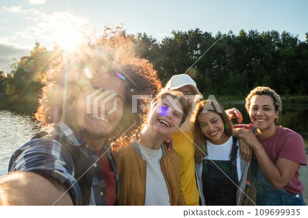 Sunshine Selfie: A Group's Moment of Joy by the Lake 109699935