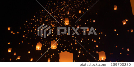 Thai people release sky floating lanterns or lamp to worship Buddha's relics at night. Traditional festival in Chiang mai, Thailand. Loy krathong Thai people release sky floating lanterns or lamp to worship Buddha's relics at night. Traditional festival in Chiang mai, Thailand. Loy krathong 109700280