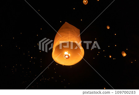 Thai people release sky floating lanterns or lamp to worship Buddha's relics at night. Traditional festival in Chiang mai, Thailand. Loy krathong Thai people release sky floating lanterns or lamp to worship Buddha's relics at night. Traditional festival in Chiang mai, Thailand. Loy krathong 109700283