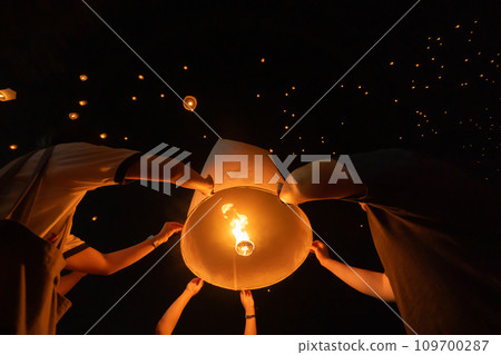 Thai people release sky floating lanterns or lamp to worship Buddha's relics at night. Traditional festival in Chiang mai, Thailand. Loy krathong Thai people release sky floating lanterns or lamp to worship Buddha's relics at night. Traditional festival in Chiang mai, Thailand. Loy krathong 109700287