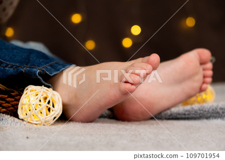 Bare feet of a small child. Cozy Christmas mood. 109701954
