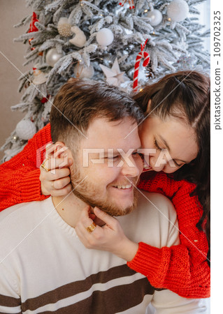 portrait of beautiful couple christmas tree on background 109702325