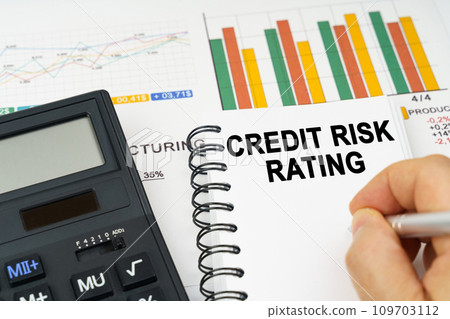 There is a calculator on the table, business charts, a man made a note in a notebook - Credit risk rating There is a calculator on the table, business charts, a man made a note in a notebook - Credit risk rating 109703112