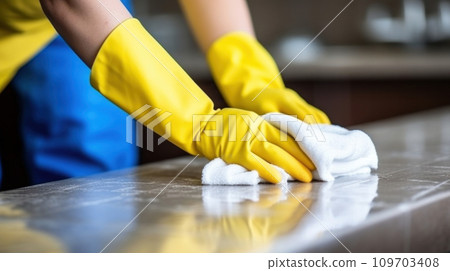 Close-up hands of man wearing yellow rubber gloves and blue trousers, with white cleaning rag. Domestic cleaning service, hygiene and cleanliness concept 109703408