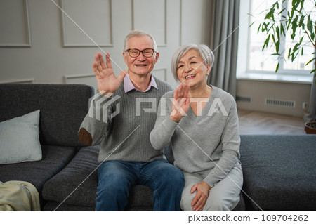 Happy senior woman man talk on video call with friends family. Mature old grandmother grandfather talking speaking with grown up children online. Older generation modern tech usage. Webcamera view Happy senior woman man talk on video call with friends family. Mature old grandmother grandfather talking speaking with grown up children online. Older generation modern tech usage. Webcamera view 109704262