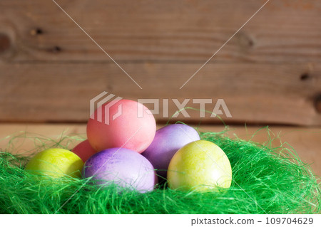 Nest with Easter eggs on wooden background 109704629