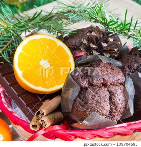 Christmas still life. Close up muffins, oranges and chocolate Christmas still life. Close up muffins, oranges and chocolate 109704683