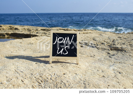 Join us symbol. Concept word Join us on black chalk background. Beautiful sea background. Business and Join us concept. Copy space Join us symbol. Concept word Join us on black chalk background. Beautiful sea background. Business and Join us concept. Copy space 109705205