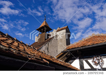 Bran Dracula Castle red tiled rooftop against blue sky in Romania Transylvania. 109705348